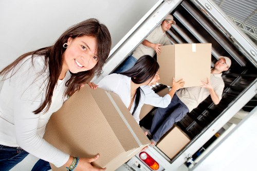 Local moving team handling boxes and furniture in East London